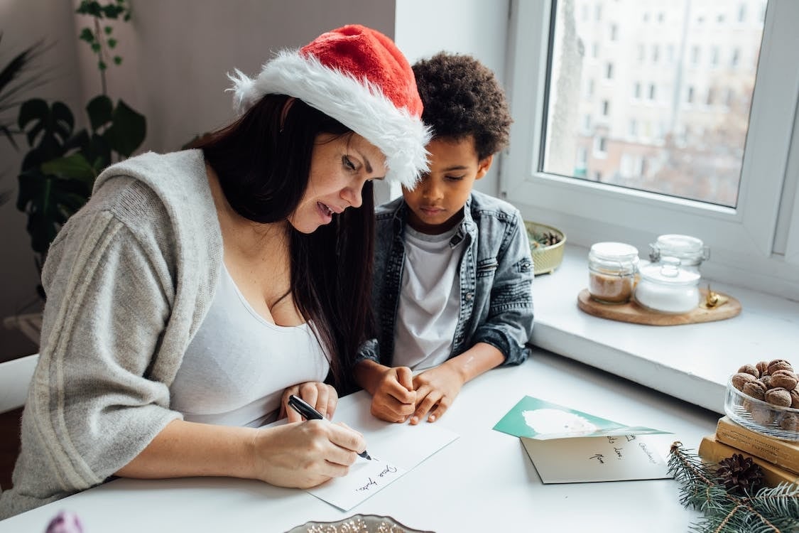 mother and child writing christmas message