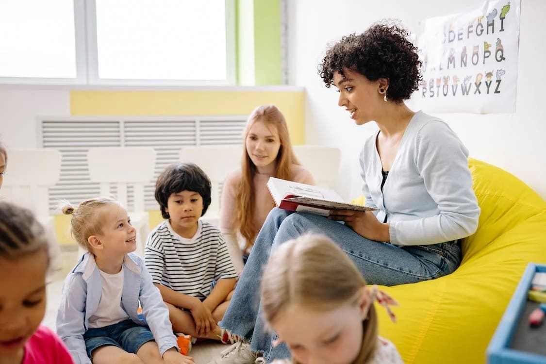 teacher reading book to children