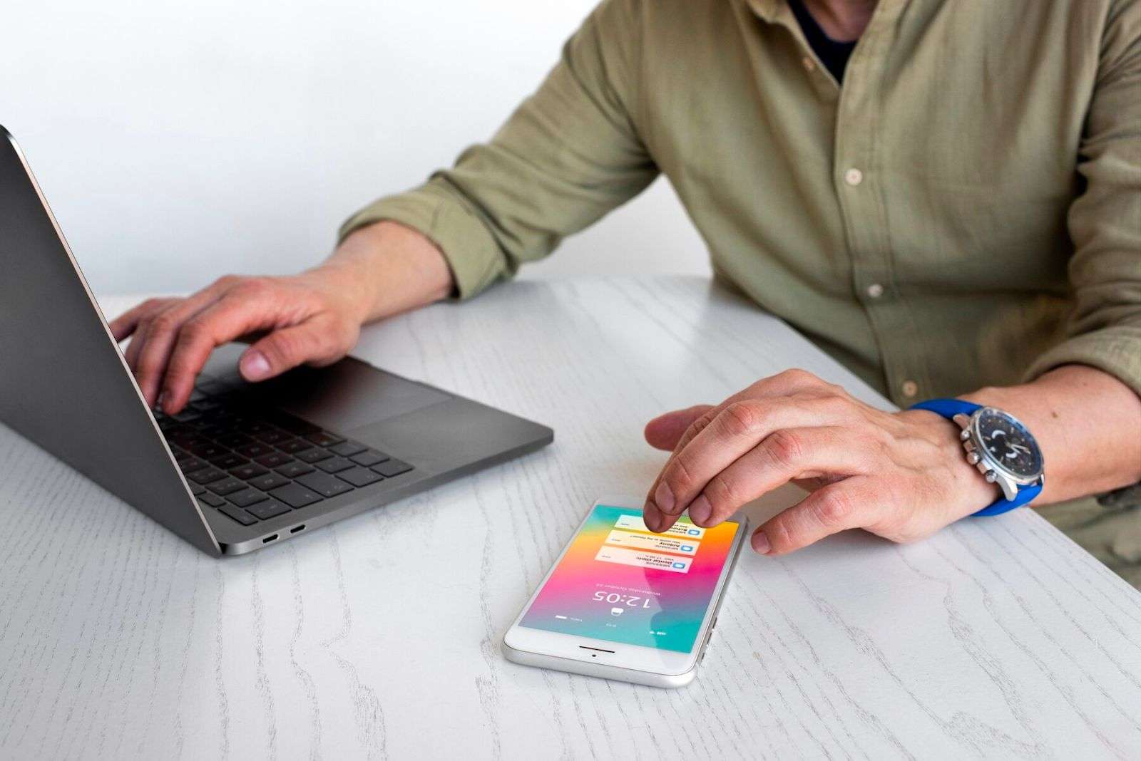 person using phone and computer